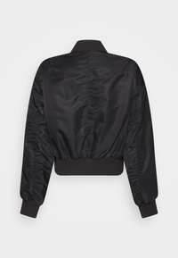 Svart bomberjacka med slät, glänsande tyg, elastiska mudd och en kortad nederkant med rynkade sidodetaljer. Inga synliga knäppningar.