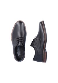 Chaussures noires en cuir avec un bout arrondi, un laçage à l'avant, des coutures blanches contrastantes et un accent texturé sur le côté.