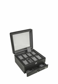 Boîte à bijoux noire avec un couvercle en verre, dotée d'un intérieur en suède. Contient 12 compartiments et un tiroir pour un espace de rangement supplémentaire.