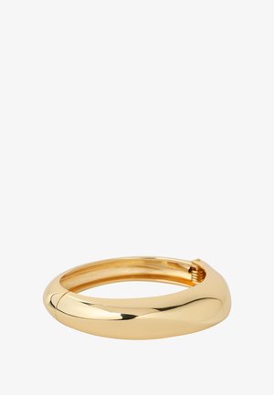 Złota bransoletka typu bangle o gładkim, zaokrąglonym kształcie i polerowanym wykończeniu. Posiada bezpieczny mechanizm zapięcia.