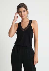 Black sleeveless top featuring a V-neck with intricate lace detailing along the neckline, made from lightweight fabric. Smooth texture.