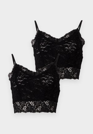 To svarte blonde braletter med tynne stropper, blomstermønster og bølgete kanter, lagt overlapper på en hvit bakgrunn.