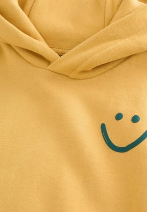 Yellow hooded sweatshirt, made of soft cotton, featuring a teal smiley face graphic on the front. Lightweight, smooth texture.