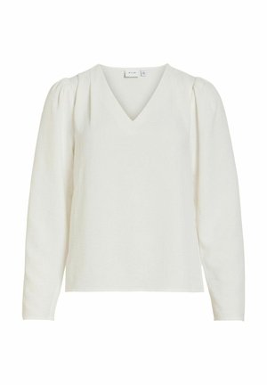 Blouse blanche à manches longues avec un col en V, texture douce et manches bouffantes structurées, présentant une coupe décontractée et un design épuré.