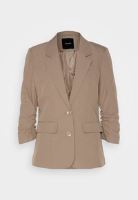 Beige skräddarsydd blazer med urklipp krage, två framfickor och uppvikta ärmar. Den har två metallknappar framtill. Slät tygtextur.