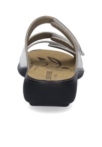 Gray sandal with multiple straps, a textured beige insole, and a solid black base. Features a subtle floral design on the insole.