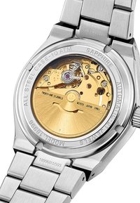 Automatické hodinky so nehrdzavejúcim oceľovým puzdrom, zlatým strojčekom, zafírovým sklom a rytými detailmi vrátane "Miyota Japan" a "21 Jewels."