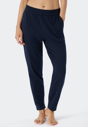 Pantaloni da lounge blu navy con vita elasticizzata, tasche laterali, gambe affusolate e texture del tessuto liscia. Design a vestibilità rilassata.