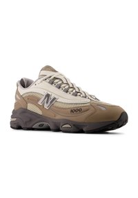 Beige and gray athletic shoes with a mesh upper, padded collar, and textured rubber sole. Features a reflective logo and number detail.