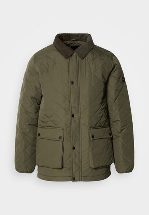 Olíva zöld steppelt dzseki kordbársony gallérral, két elülső zsebbel és fekete nyomógombokkal. Az anyag sima tapintású és gyémánt mintázatú.