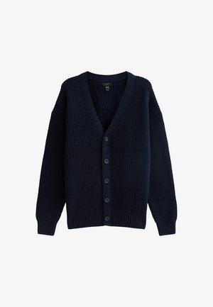 Cárdigan de punto azul marino con escote en V, textura acanalada, mangas largas y seis botones en la parte frontal. Presenta hombros amplios y caídos, y un corte holgado.