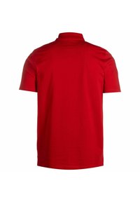 Polo shirt rosso a maniche corte realizzato in cotone liscio, con colletto classico e orlo dritto. Senza loghi o motivi visibili.