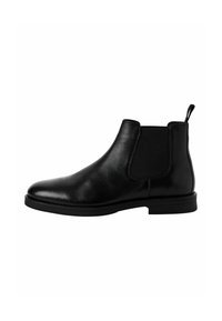 Bota Chelsea de cuero negro con paneles laterales elásticos, punta redonda y una lengüeta. Suela de goma plana para tracción. Textura suave.