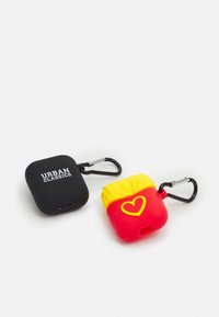 Two AirPods cases, one black silicone with "URBAN CLASSICS" logo, and one red silicone resembling fries with yellow accents and heart detail.