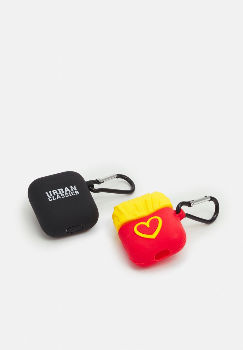 Two AirPods cases, one black silicone with "URBAN CLASSICS" logo, and one red silicone resembling fries with yellow accents and heart detail.