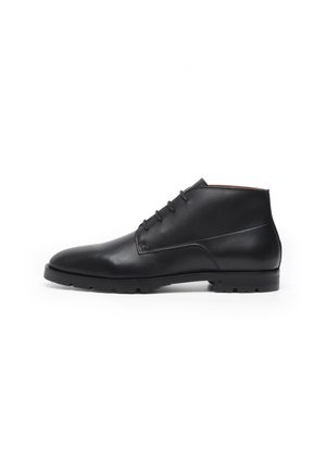 Black leather ankle boots with a smooth texture, rounded toe, lace-up design, and a rubber sole suitable for various terrains.
