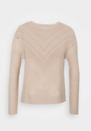 Beige knitted sweater with long sleeves, featuring a V-shaped pattern on the bodice and ribbed neck. Textured, casual design.