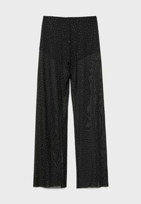 Czarne spodnie o szerokich nogawkach z przezroczystego materiału, pokryte równomiernie rozmieszczonymi małymi białymi kropkami.