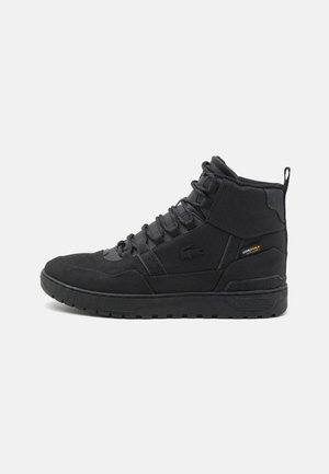 Black high-top sneakers made of suede and textile, featuring a padded collar, lace-up closure, and a textured rubber sole.