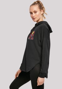 Sudadera negra con un colorido diseño gráfico en la parte frontal, corte holgado, capucha con cordón y dobladillo curvado.
