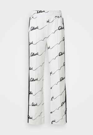 Calças de algodão brancas com um padrão repetido em preto. Design de perna reta com uma faixa elástica na cintura e riscas laterais.