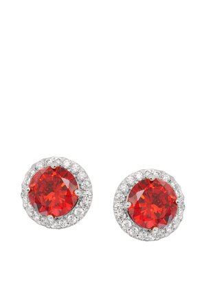 Pair of round silver stud earrings with large red gemstones surrounded by small clear crystals on a white background.