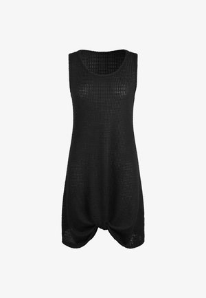 Tunique sans manches noire en tissu tricoté texturé, présentant un col arrondi et un détail froncé à l'ourlet pour une coupe décontractée.