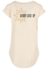 Light beige T-shirt features a rounded hem, short sleeves, and a sun graphic with the text "KEEP YOUR SUNNY SIDE UP" in black. Soft texture.