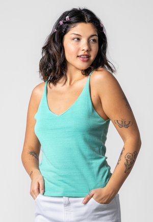 Light teal sleeveless tank top with a V-neck design, made of soft material. Features narrow shoulder straps and a fitted silhouette.