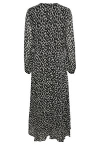 Robe longue à imprimé léopard noir et blanc, avec des manches longues semi-transparentes et une taille cintrée, vue de dos.