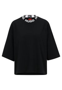 T-shirt nera oversize in cotone, con scollatura tonda bordata in bianco con marchio. Maniche corte e larghe e orlo dritto.