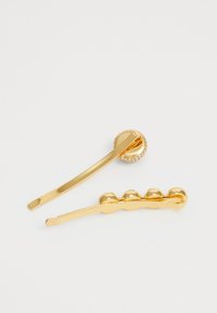Two gold hair clips on a white background, one with a round crystal-studded end, the other with four rounded bead-like details.