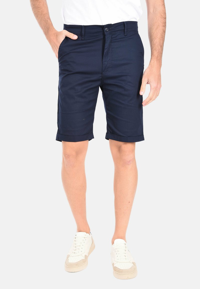 Bermuda chino blu navy con vestibilità slim, dotate di orli arrotolati, due tasche anteriori e chiusura a bottone. Tessuto in cotone liscio.