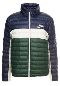 Nike puffer-jacka med hög krage, med en färgblockdesign i marinblått, vitt och mörkgrönt. Tillverkad av vadderat material med en framdragkedja.
