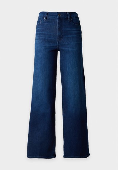 Jean bleu foncé taille haute, coupe large aux jambes, avec bouton sur le devant et poches, présenté sur un fond blanc uni.