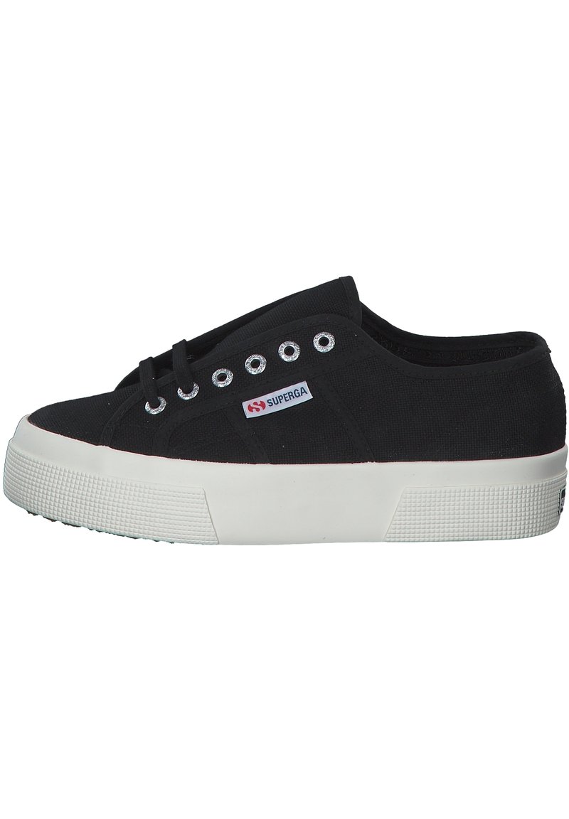 Black canvas sneaker with a lace-up design, white rubber sole, and textured grip. Features silver metal eyelets and a small logo tag.