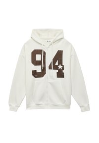 Weißer Zip-Hoodie mit großem braunem "94"-Grafik und Stern. Weiches Material mit lockerer Passform, ausgestattet mit einer Kordelzugkapuze und Vordertaschen.