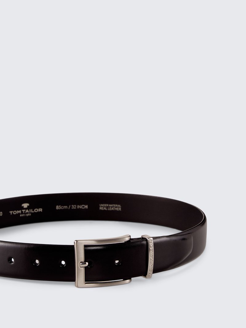 Black leather belt with a silver metal buckle and engraved logo, featuring five holes for adjustment. Length: 85 cm (32 inches).