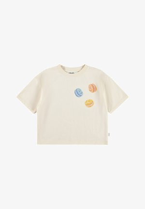 T-shirt à manches courtes crème en coton, orné de macarons brodés colorés en bleu, orange et jaune sur le devant.