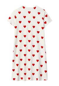 Vestito a maniche corte in cotone bianco con motivi di cuori rossi sparsi. Collo tondo e vestibilità relax con orlo che termina sopra il ginocchio.