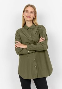 Khaki košile na knoflíky s límečkem, dlouhými rukávy a zaobleným lemem. Vyrobena z hladkého materiálu, s knoflíkovým zapínáním a volným střihem.