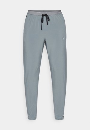 Hallid harjad, mis on slim fit'iga, elastse vöökoha, paelaga ja õrna Nike logoga. Valmistatud kergest ja siledast kangast.
