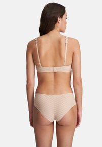 Beige bra with floral appliqué straps and textured back; matching high-waisted brief with a light checkered pattern.