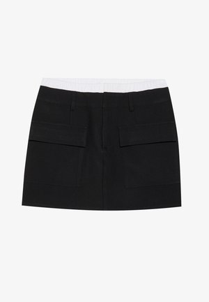 Must must, mis valmistatud kootud kangast, millel on valge elastne vöökoht ja kaks suurt esi-taskut. Sirge lõikega disain, ilma mustriteta.