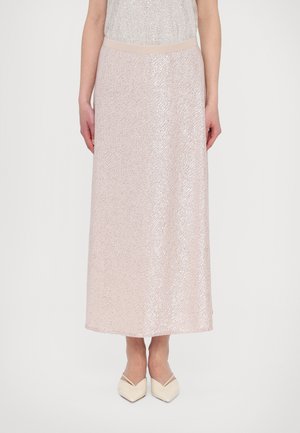 Pale pink sequined maxi skirt with a smooth waistband, featuring a textured surface and a flowing silhouette, paired with pointed white heels.