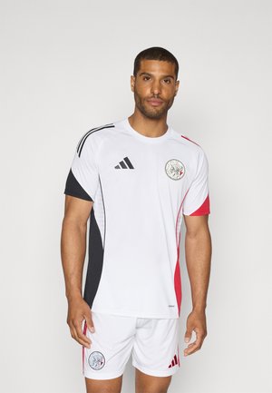 White sports jersey with black and red accents, featuring black Adidas stripes on the shoulders and a circular logo on the chest. Matching white shorts.