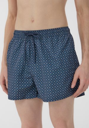 Pantaloni da bagno blu navy realizzati in tessuto leggero, con un piccolo motivo geometrico bianco, cintura elastica e cordino per la regolazione.