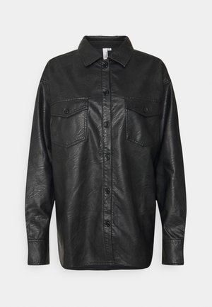 Black faux leather shirt jacket with long sleeves, front button closure, and two patch pockets on the chest. Smooth texture, collared neck.