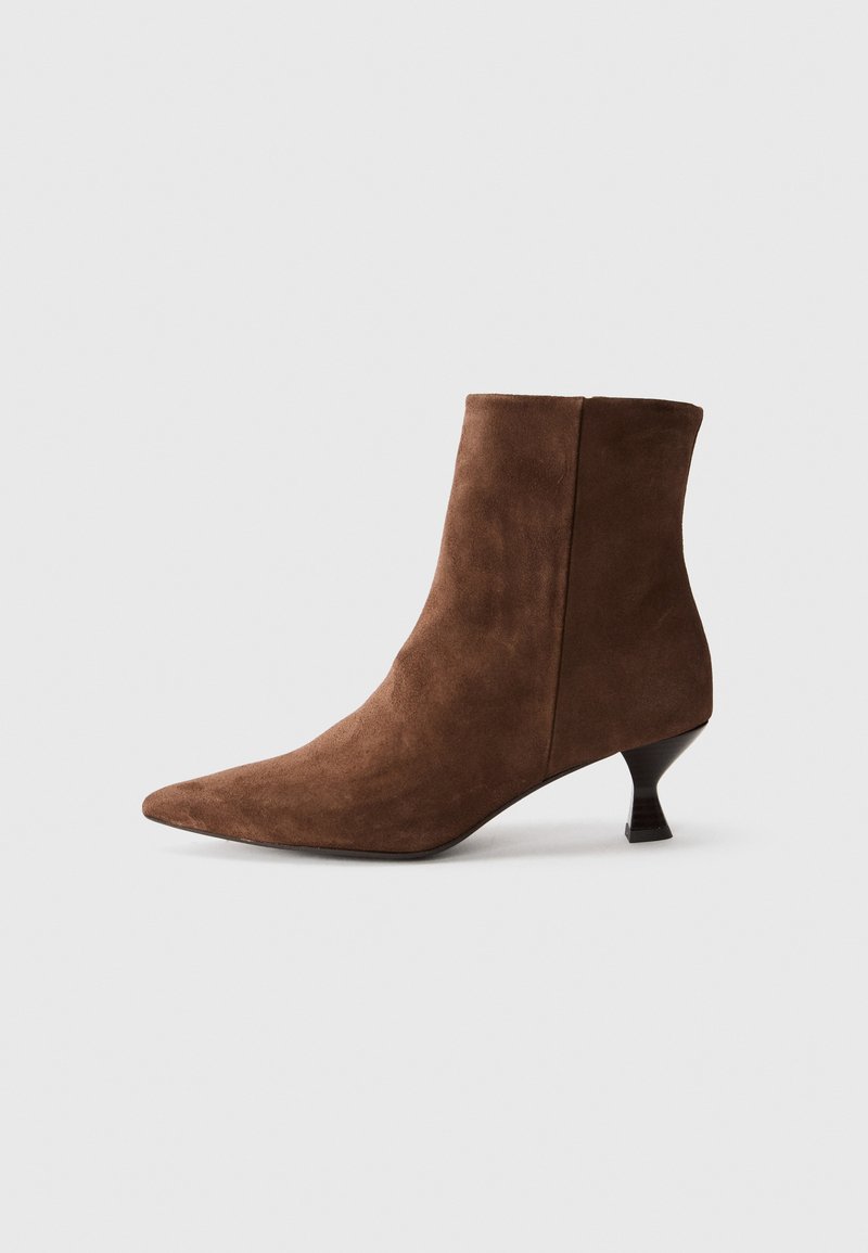 Brown suede ankle boot with a pointed toe and a kitten heel. Features a smooth texture with seamless sides and a minimalist design.