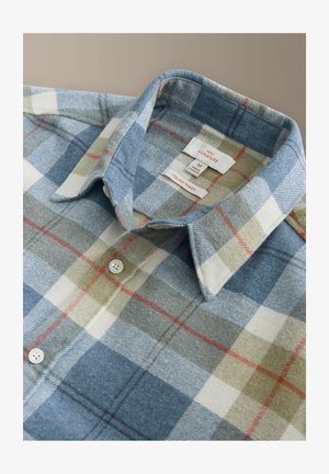 Medvilninis flanelinis marškiniai su mėlynais ir smėlio spalvos langeliais, baltais akcentais ir sagomis užsegamu apykakle. Pagaminti iš minkštos itališkos medžiagos. Matoma M dydžio etiketė.